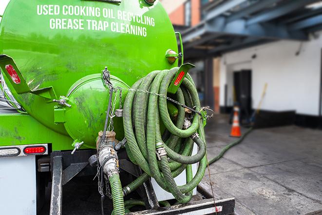 a professional technician pumping a restaurant's grease trap in Burns Harbor